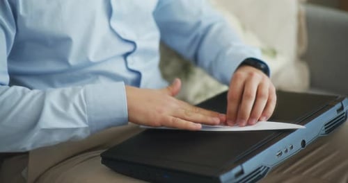 Businessman Looks for Relaxation Folding Paper Airplane