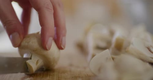 Slicing White Mushroom on Wooden Cutting Board