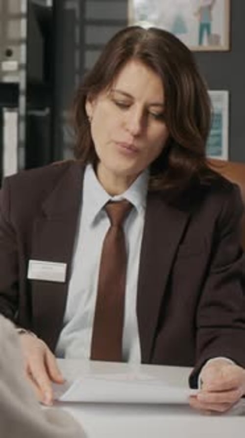 Business Woman Explains Document in Modern Office Setting