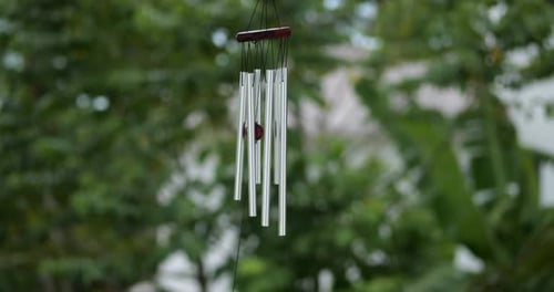 Silver Wind Chime Gently Swaying in the Breeze