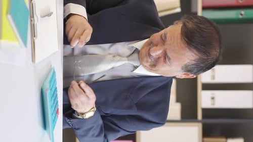 Stressed Out Adult Massages Face at Desk