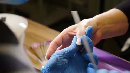 Nail Master in Gloves Makes Professional Manicure in Beauty Salon Closeup Close Up of Professional