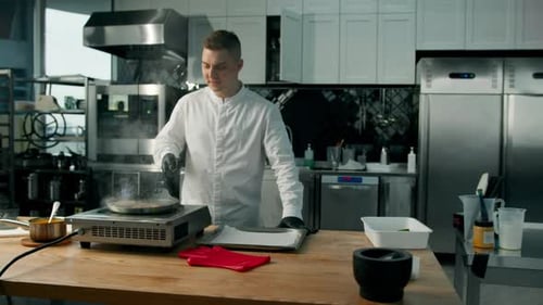 professional kitchen: the chef is frying patties for a burger