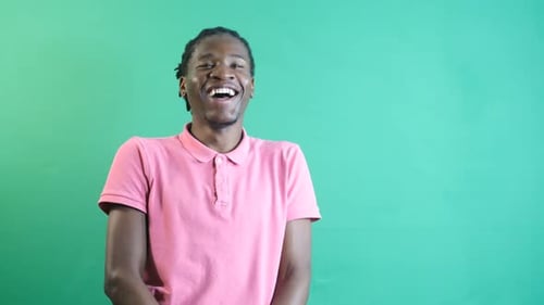 Young Adult Laughing in Front of Green Screen