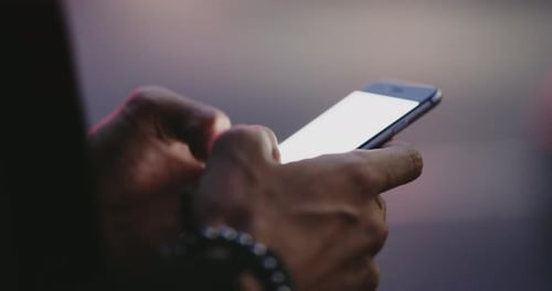 4k video footage of an unrecognizable man using a cellphone in the city