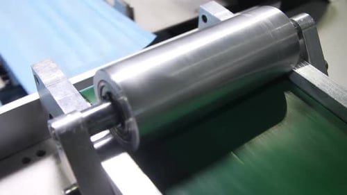 Line Transports Cut Blue Fabric Sheets for Protective Masks