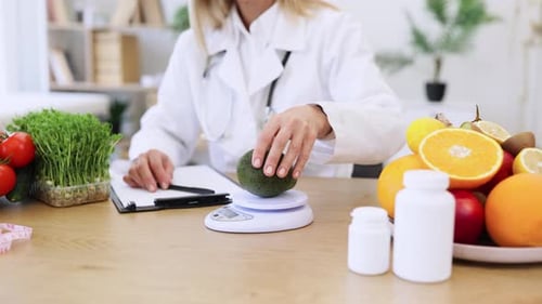 Close Up of Hands of Mature Female Nutritionist Making Healthy Eating Plan