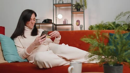 Young Woman Using Credit Bank Card and Smartphone Transferring Money Purchases Online Shopping