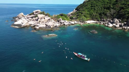 Aerial view of people snorkelling in shark bay on Ko Tao island, Thailand.