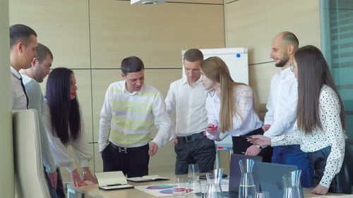 Strong Diversified Business Team Discussing Project Achievement in Modern Office