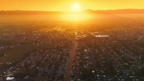 Flyover the beautiful scenery of Napa city in California. Orange sky over the hazy mountains