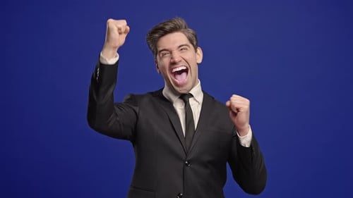 Businessman in Suit is Very Glad and Happy He Shows Yes Gesture of Victory with Clenched Fist Guy