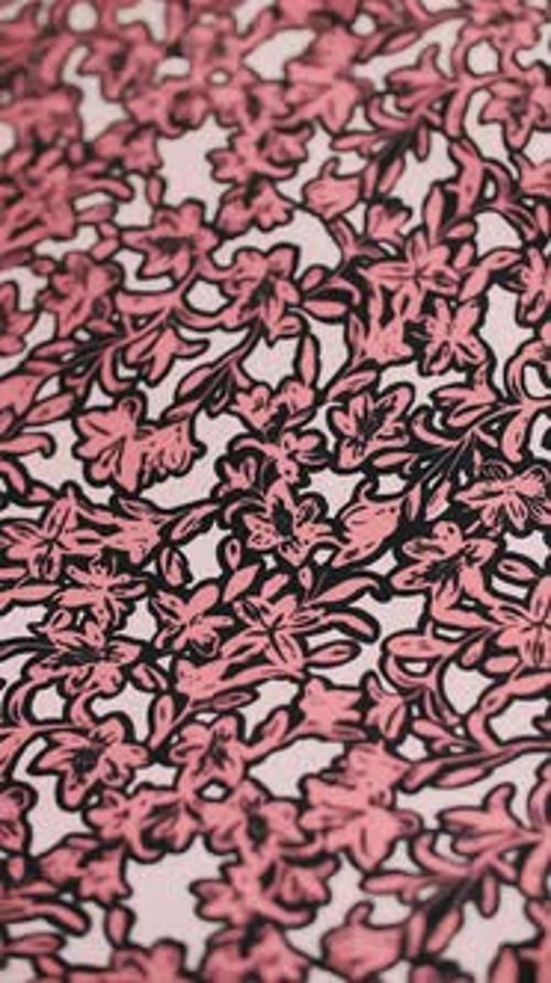 Stylized Flower Pattern on Pink Fabric