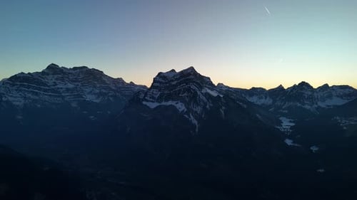Winter nature alpine landscape Fronalpstock mountain summit range Switzerland, aerial drone