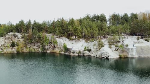 Aerial View of Small Island with Pine Trees in the Middle of the Lake