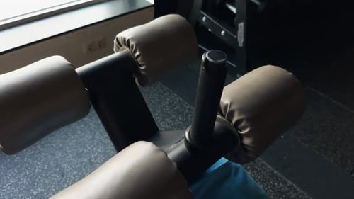 a Press Bench is Sitting on a Tiled Floor in a Gym