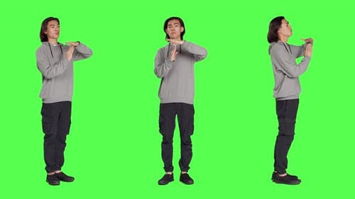Young Adult Making Time Out Gesture on Chroma Key