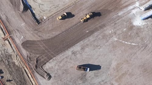 Aerial View of a Yellow Excavator That is Building a Road Grader a Heavy Soil a Bulldozer That is