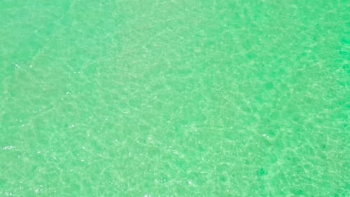 Sea Surface in a Turquoise Lagoon Top View Transparent Turquoise Sea Water Natural Background