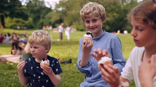 Three Kids Enjoying Picnic in Park