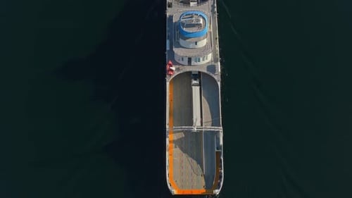 Electric vessel moves fast across mirror-like fjord, Norway aerial