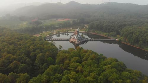 Aerial view of abandoned waterpark by lake at sunrise, Vietnam.