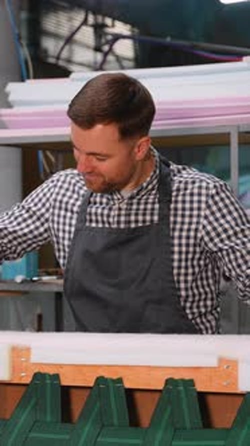 Man Using Staple Gun in a Workshop