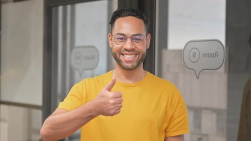 Man Gives Thumbs Up in the Office