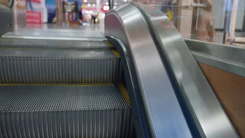 Close Up Of Escalator Ascending In Modern Shopping Mall