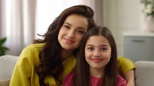 Loving Mother and Daughter Embrace Indoors