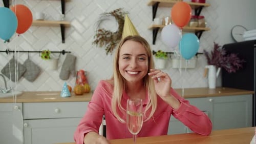 Woman Celebrating Birthday with Sparkling Wine