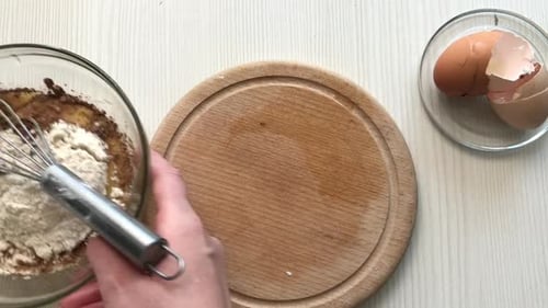 A Woman Mixes Dough Ingredients With A Whisk. Preparing Waffle Cones. Close Up Shot From Above.