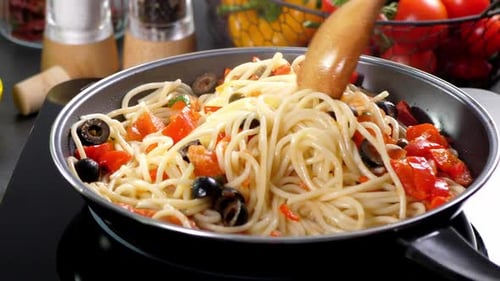 Cooking Spaghetti with Tomatoes and Olives in Pan