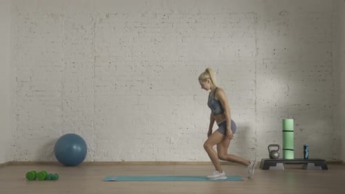 Athletic Woman Exercising Core Muscles on Mat