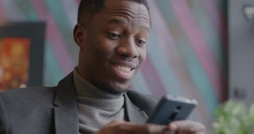 Young Adult Using Cellphone Indoors
