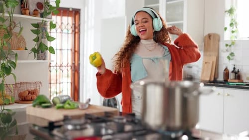 Woman Dancing in Kitchen while Cooking Dinner