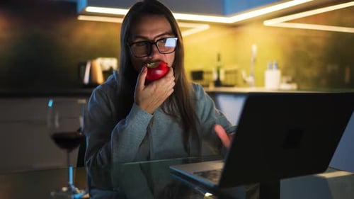 Woman Working on Laptop Computer at Home at Night