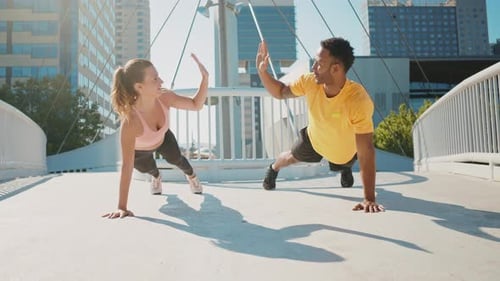 Athletic Duo Doing Push-Ups in the City
