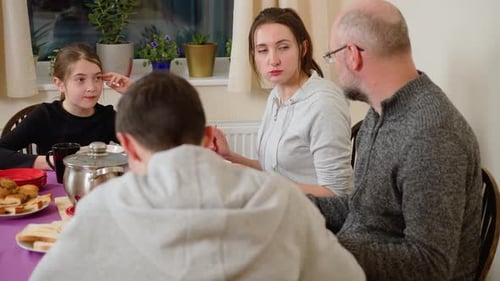 Family Mealtime at Home Around Dining Table
