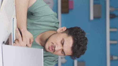 Vertical video of Male student suffering from back pain.
