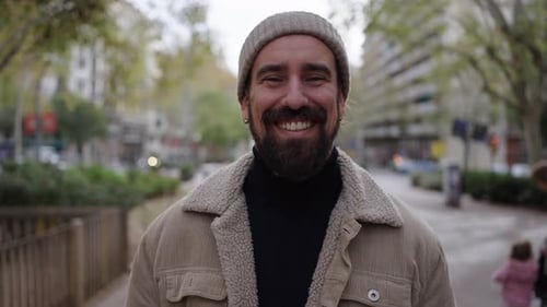 Portrait of a Happy Handsome Man Smiling Looking at Camera Standing Outdoors in a Street City