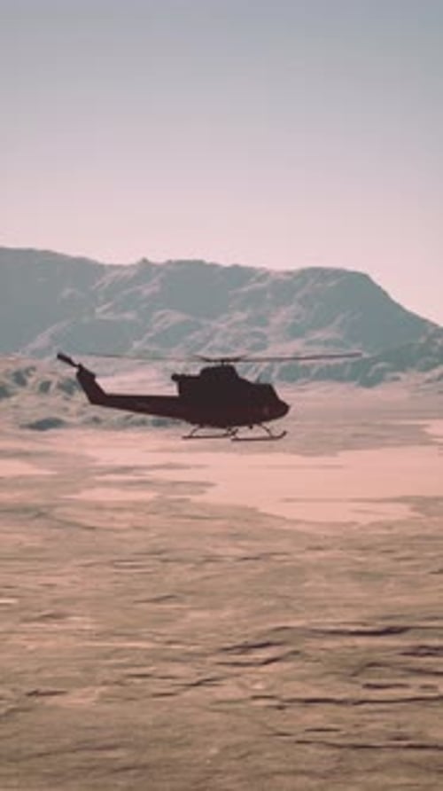 Vintage American Military Helicopter at Sunset on Icy Terrain