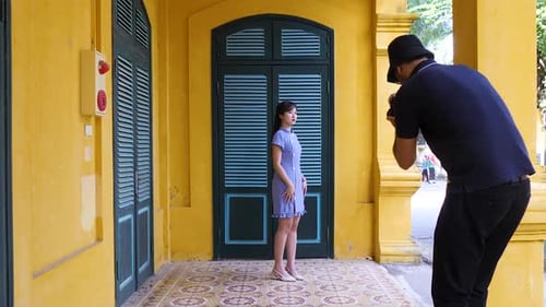 Model Poses for Photographer in Urban Setting