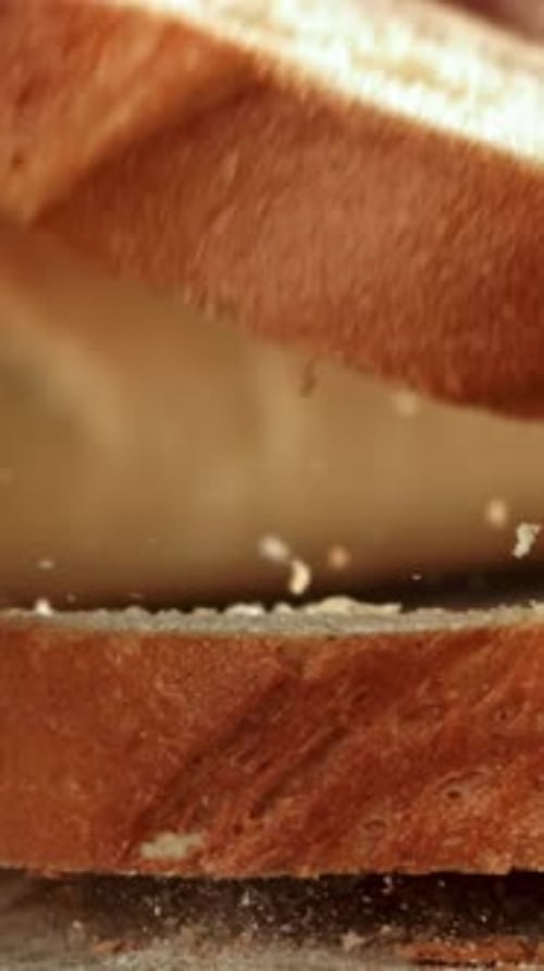 Sliced Bread Falls Onto a Cutting Board Filmed on a Highspeed Camera at 1000 Fps