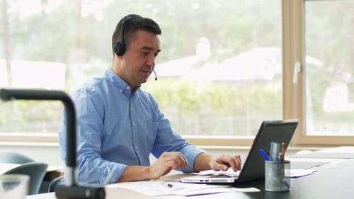 Happy hispanic businessman working remotely from home office using laptop computer