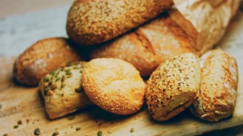 Assorted Freshly Baked Bread on Wooden Board