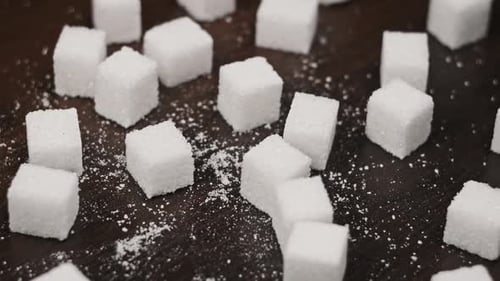 Sugar Cubes Rotate on the Table CloseUp