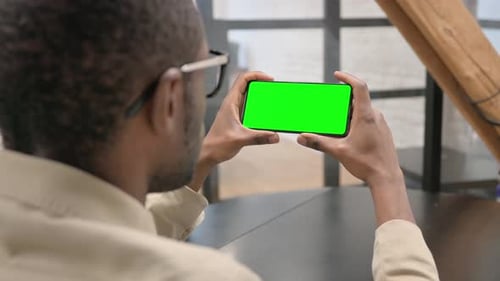 African Man Holding Phone with Green Screen