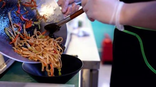 Preparing Colorful Noodles with Vegetables in Restaurant