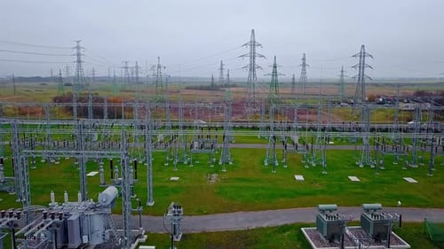 drone shot of electricity power station. Aerial footage of high voltage power towers connected with